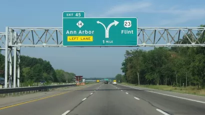 Green highway signs on Highway 23 for Ann Arbor and Flint, Michigan.