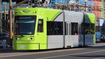 Green and gray Tempe streetcar on street in Tempe, Arizona
