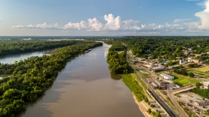 A diversion canal from the Yazoo River is shown from above. The river's banks are lined with industrial land uses near the city of Vicksburg, Mississippi.