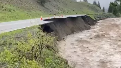Floodwaters and damaged road in Yellowstone National Park