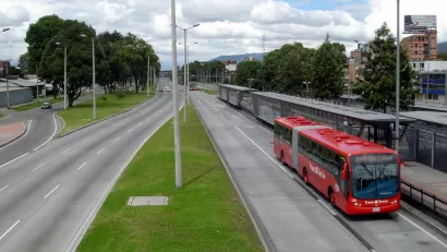 Red transmilenio bus stopped at station in Bogota