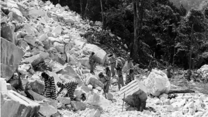 Incarcerated people work in a rock quarry, possibly Keith Quarry near Palmetto, Georgia, around 1948.