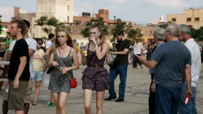 Young and all people stroll at a community event in New York City.
