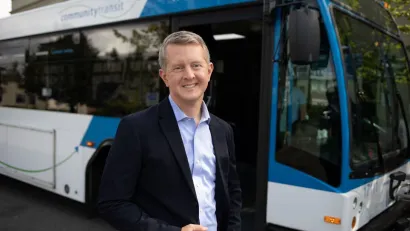 Ken Jennings stands in front of Snohomish County Community Transit bus.