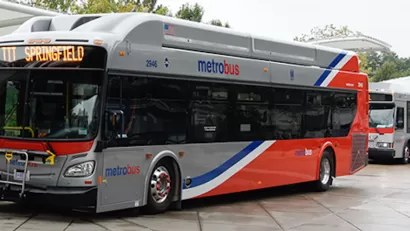 Silver and red WMATA public bus at station in Washington, D.C.