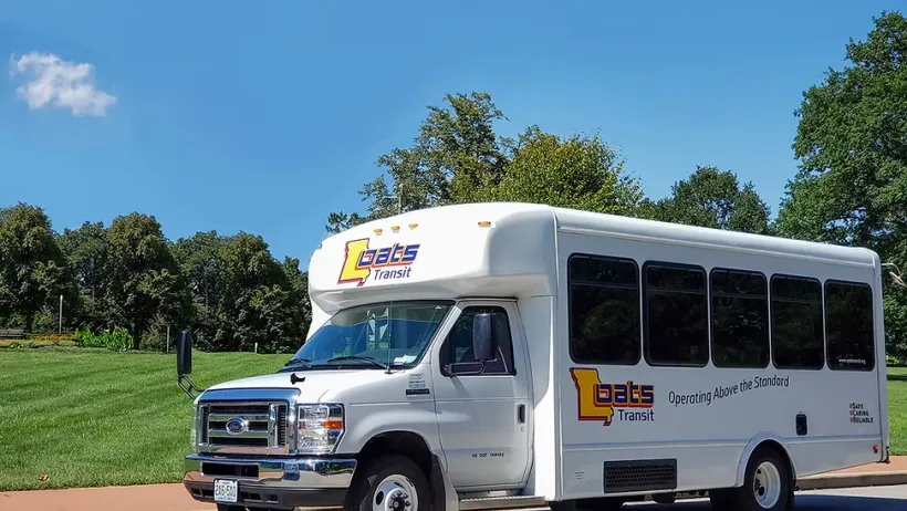 White on-demand microtransit transit vehicle in Missouri.