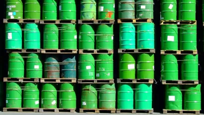 pallets of green oil barrels stacked
