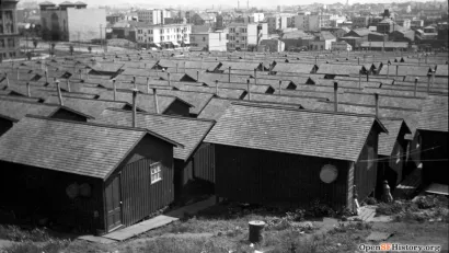 Black and white photo of refugee camp of small wood cottages in Dolores Park, San Francisco CA after 1906 earthquake.