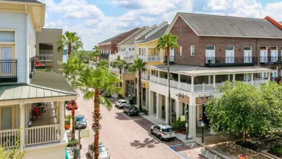 Two-story buildings with porches in walkable Florida neighborhood.