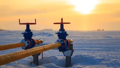 Two yellow pipes for natural gas or oil agains ta backdrop of snow