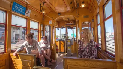 Passengers inside wood-paneled TECO streetcar in Tampa, Florida