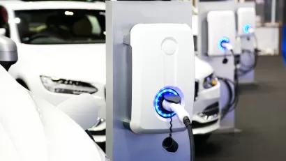Row of white electric cars at charging station