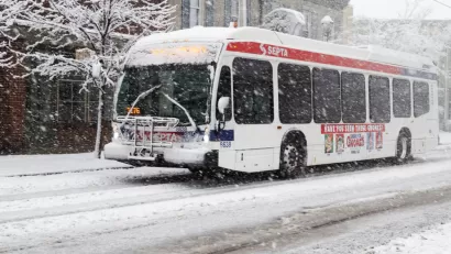White SEPTA bus driving through snow in Philadelphia, Pennsylvania