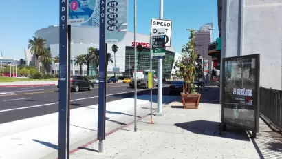 Bus stop in downtown Los Angeles with billboard and no bench or shelter