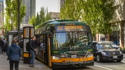 Bus stop with passengers and bus in downtown Seattle