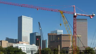 Construction crane in foreground, Denver skyline in background