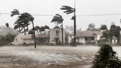 Flooded street with palm trees bending in the wind during Hurricane Irma in Ft. Lauderdale, Florida