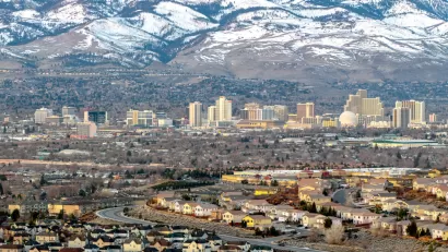 Aerial view of Reno, Nevada against snow-capped mountains in winter