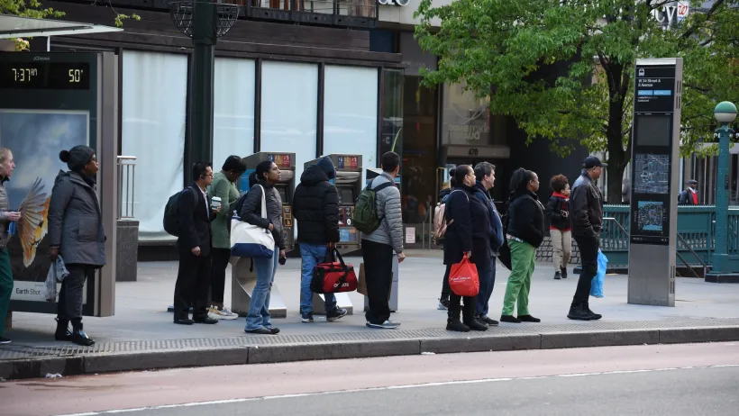 People waiting at bus stop in New York City.