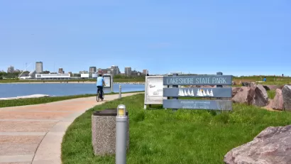 A cyclist on a path in Lakeshore State Park in Milwaukee Wisconsin