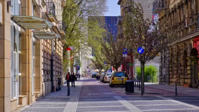 Woonerf street with no curbs and trees in Lodz, Poland