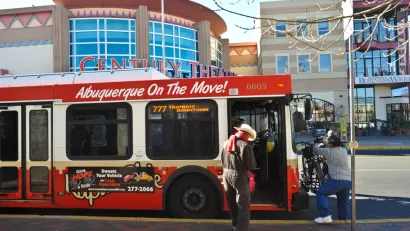 Red Albuquerque bus with man boarding