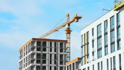 Apartment buildings under construction with crane.