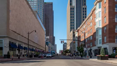 Broad street in downtown Columbus, Ohio with two pedestrians in crosswalk