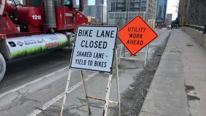 "Bike Lane Closed" and "Utility Work Ahead" signs on Chicago bike lane