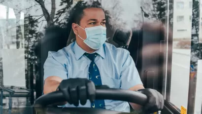 Bus driver wearing a COVID-19 protective mask