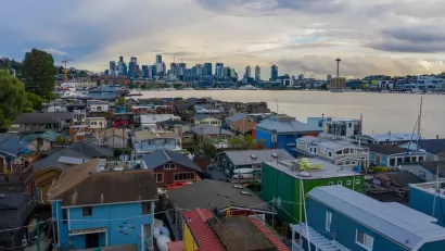 View of downtown Seattle across a body of water with colorful houses in the foreground