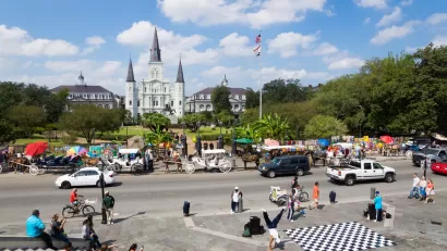 View of Jackson Square, New Orleans with cathedral and street dancers in foreground