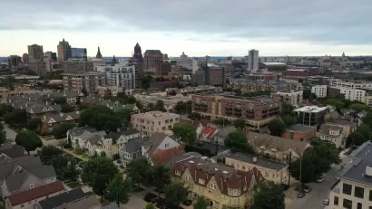 Aerial view of Milwaukee, Wisconsin skyline with large old homes in the foreground