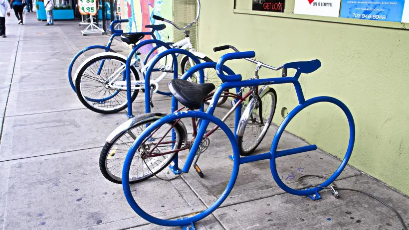 Blue bicycle-shaped bike racks on sidewalk in Las Vegas, Nevada.