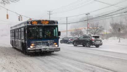 CTtransit bus driving through snowy street in Norwalk, Connecticut