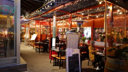 Italian restaurant outdoor dining patio with string lights in New York City
