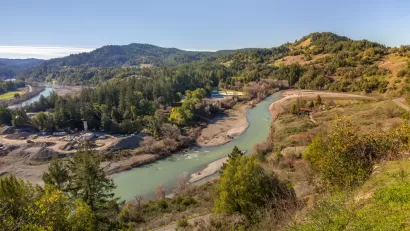 Aerial view of Eel River running through California forest