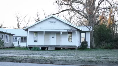 Dilapidated vacant wood slat house painted white in Louisiana