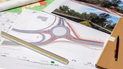 Diagram of a roundabout and site photos laid out on a desk