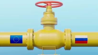 Yellow gas pipeline with E.U. flag on one side and Russia flag on the other side