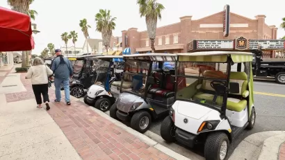 Line of golf carts parked on street in The Villages, Florida