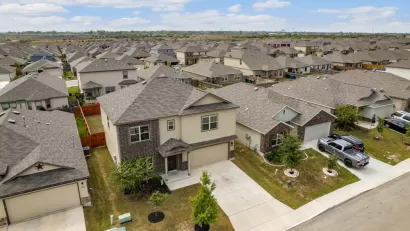 Low aerial view of two-story suburban Houston homes