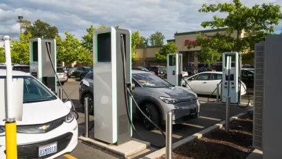 Electric car charging station with several Chevy Bolts charging in parking lot of store in Bellingham, Washington