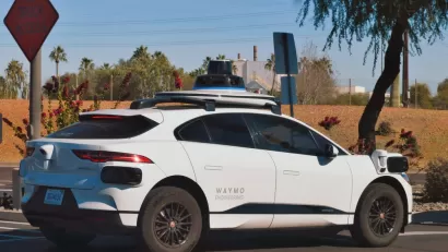 Self-driving white Waymo Jaguar SUV on street in Chandler, Arizona