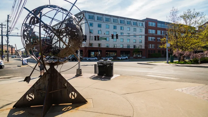 Plaza in Portland, Maine with statue of globe with compass rose.