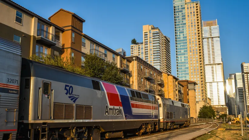 Amtrak train with Austin high-rises in the background.