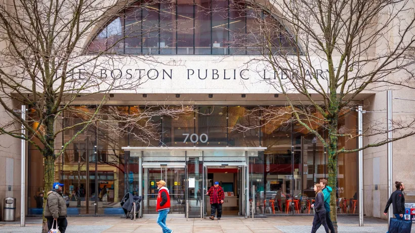 Facade of Boston Public Library branch with title etched in stone above doorway.