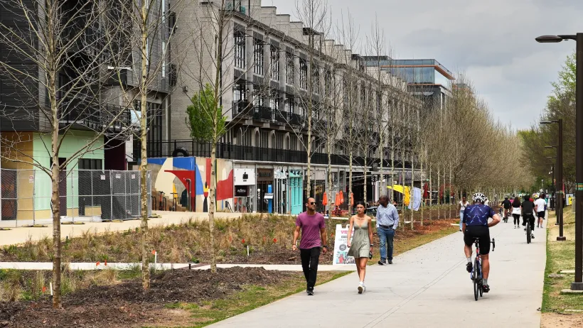 People walking and biking on Atlanta Beltline paved trail.