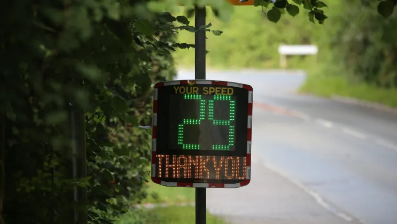 Electronic sign on roadside with 29 in green and Thank You in yellow below it.