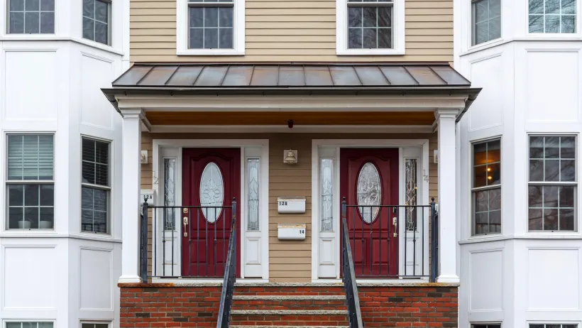 Two-story duplex with matching dark red doors in Boston, Massachusetts.
